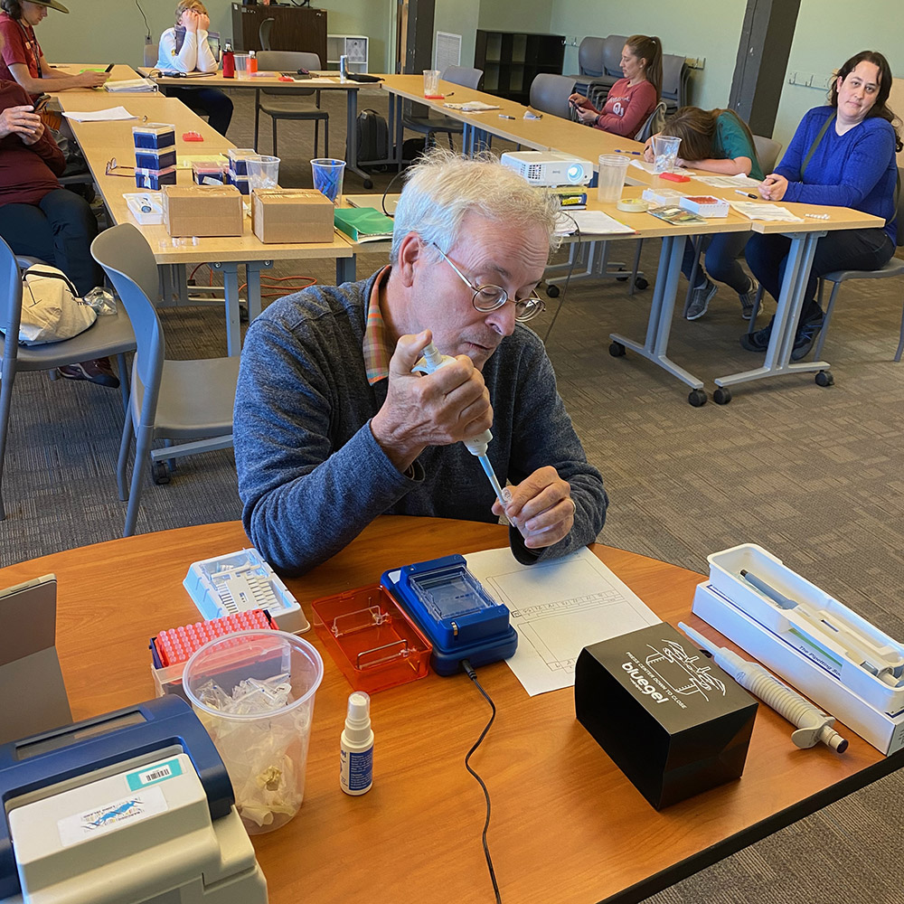Photo of a man using scientific research tools during a US Ants DNA sequencing workshop.